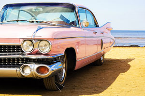 Pink Cadillac parked on the beach
